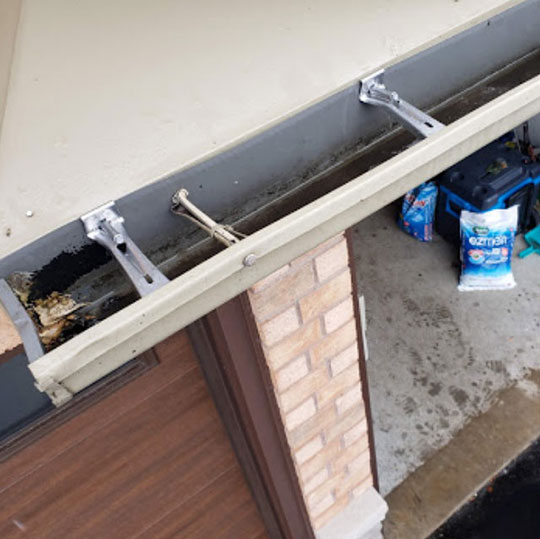 cleaning eavestrough for client home by Solid Eavestrough